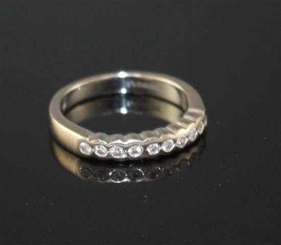 A modern 18ct white gold and ten stone diamond chip set half eternity ring, size M, gross weight 4.5 grams.